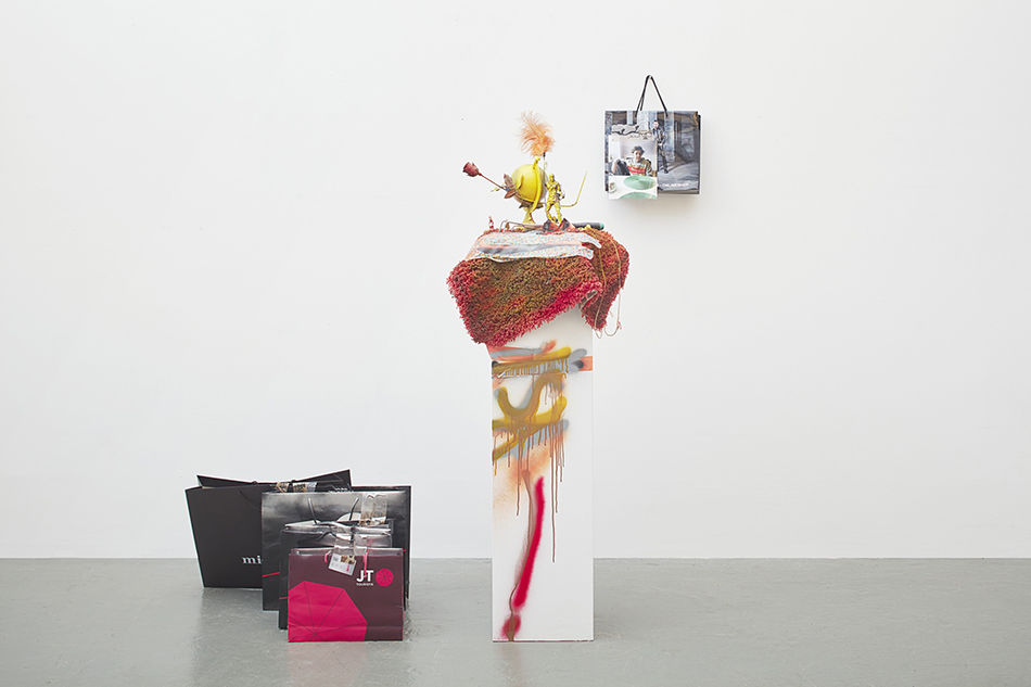 Untitled, 2016, Isa Genzken. Pedestal, rug, spray paint, mixed media (globe, feather, plastic toy figures, artificial rose, carpet, tape, spray paint, wooden pedestal, 5 paper bags with tape, plastic tube, plastic card, photograph). Sculpture, 190 x 70 x 60 cm / 74.8 x 27.5 x 23.6 inches bags 50 x 120 x 110 cm / 19.6 x 47.2 x 43.3 in. Courtesy the artist, Hauser & Wirth and Galerie Buchholz Cologne / Berlin / New York © Artists Rights Society (ARS) New York / VG Bild-Kunst, Bonn. Photo: Nick Ash