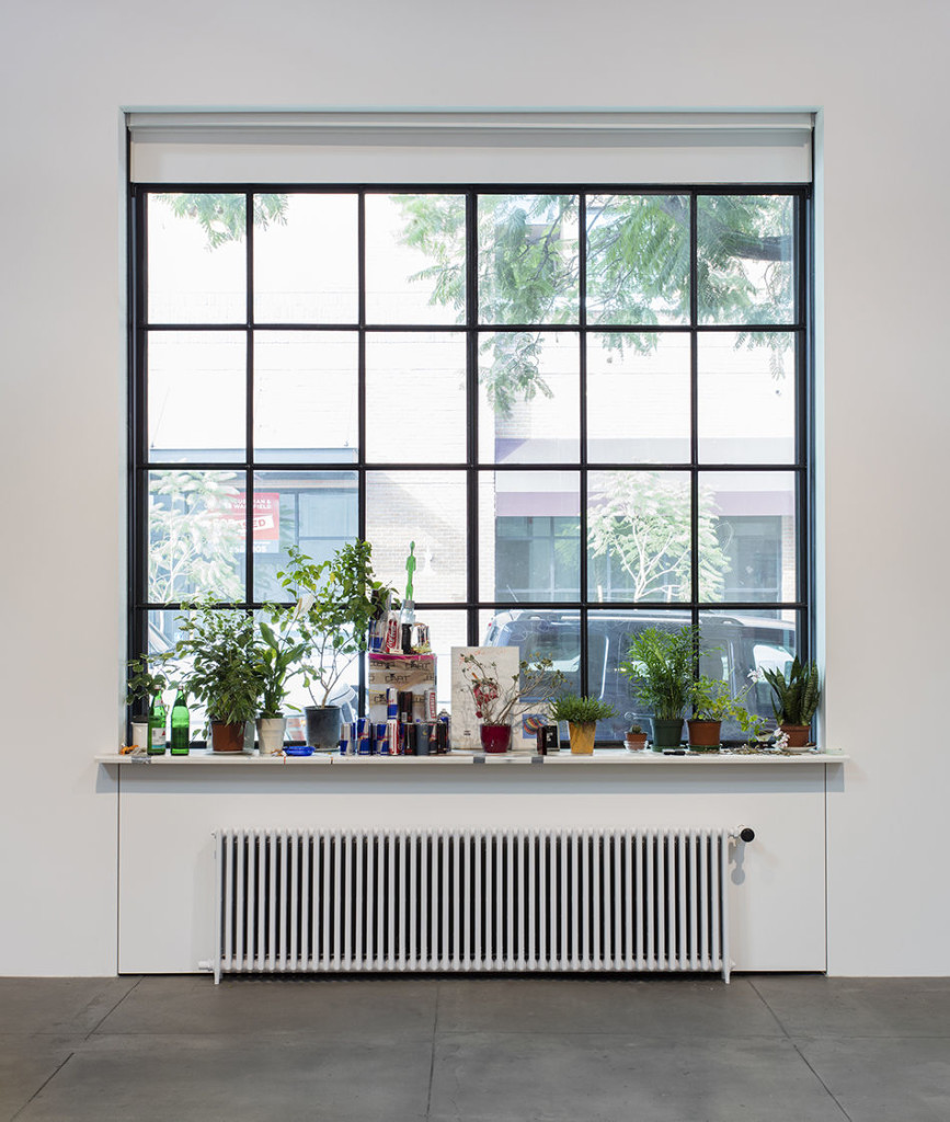 Untitled, 2016. Isa Genzken. Window, windowsill, radiator, plants, coins, aluminum cans, found objects. Dimensions variable. Courtesy the artist, Hauser & Wirth and Galerie Buchholz Cologne / Berlin / New York. © Artists Rights Society (ARS) New York / VG Bild-Kunst, Bonn. Photo: Brian Forrest