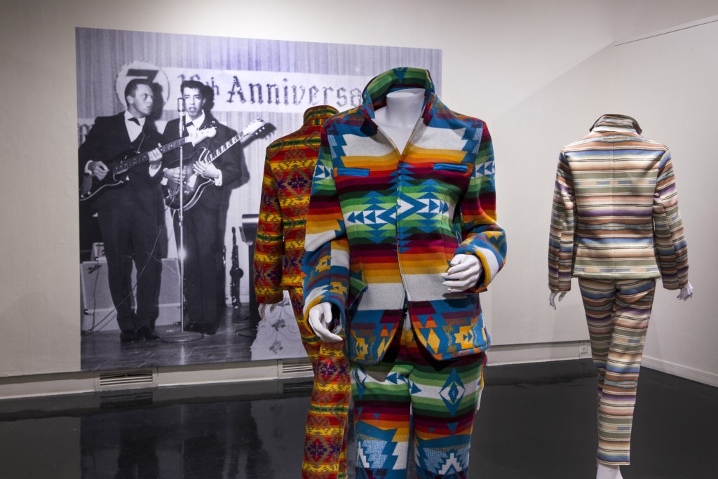 Pendleton Suits and The Maniacs Performance Photo featuring Wallace Red Star, Jr. at right, Wendy Red Star: The Maniacs (We're Not The Best, But We're Better Than The Rest), University Art Gallery, New Mexico State University. Photo Courtesy of Mónica Martínez. 