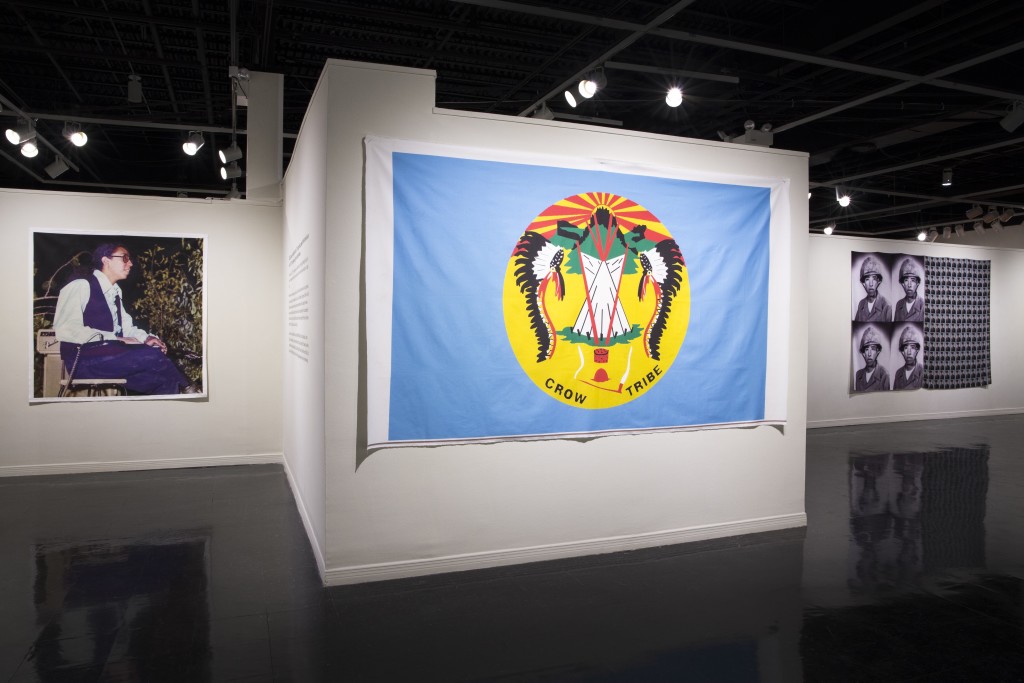 Caption: Image of Wendell Red Star, Crow Nation Flag, and Wallace Red Star, Jr., Wendy Red Star: The Maniacs (We're Not The Best, But We're Better Than The Rest), University Art Gallery, New Mexico State University. Photo Courtesy of Mónica Martínez. 