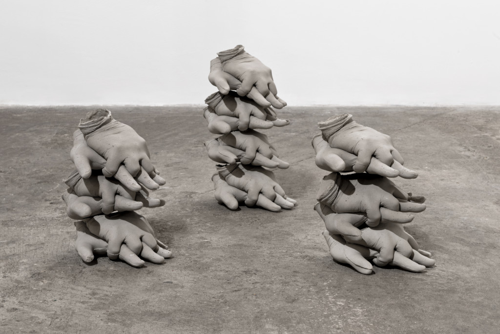 Ewa Axelrad, Minimum, Necessary, Objectively Reasonable #1, 2015. Stacks of life-size hands in a CPR position, concrete composite (dimensions variable).